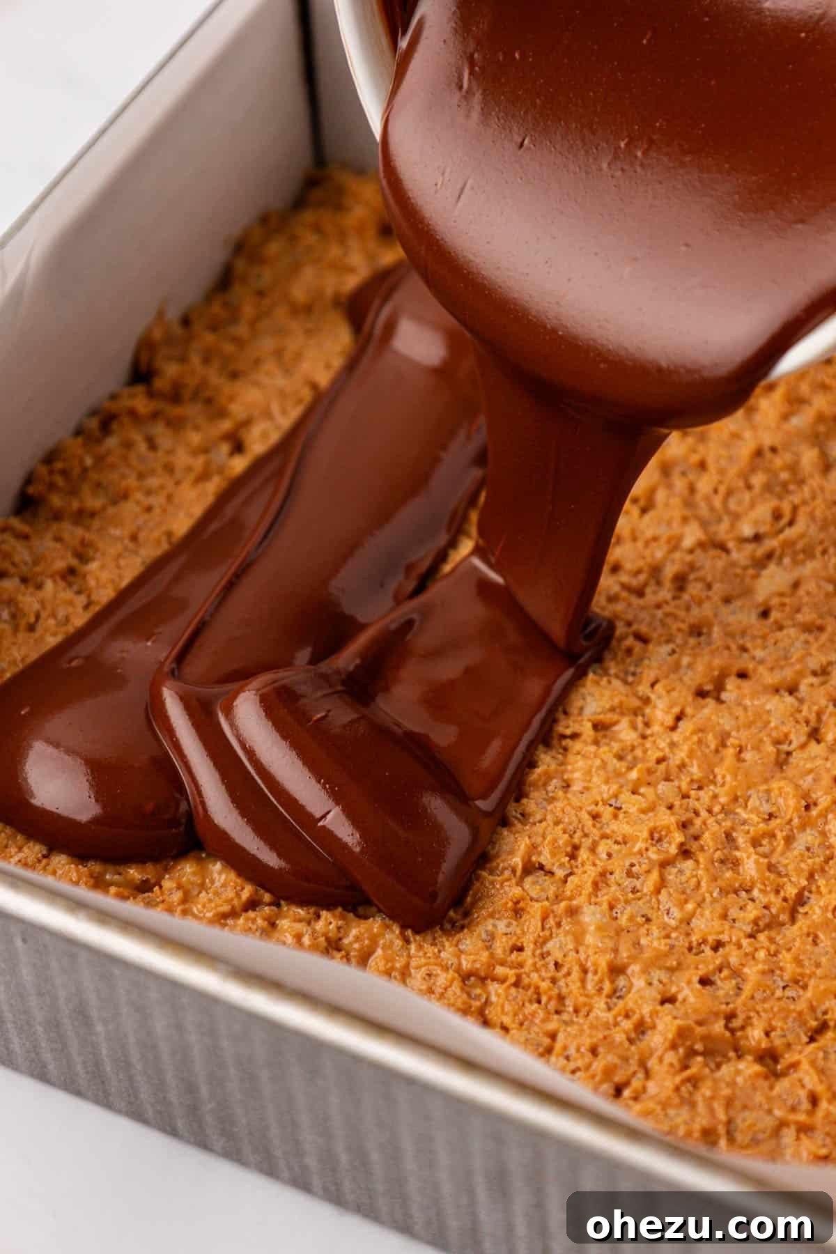 Chewy Peanut Butter Rice Krispie Bars Recipe 13 pouring the melted chocolate over the rice krispie bars