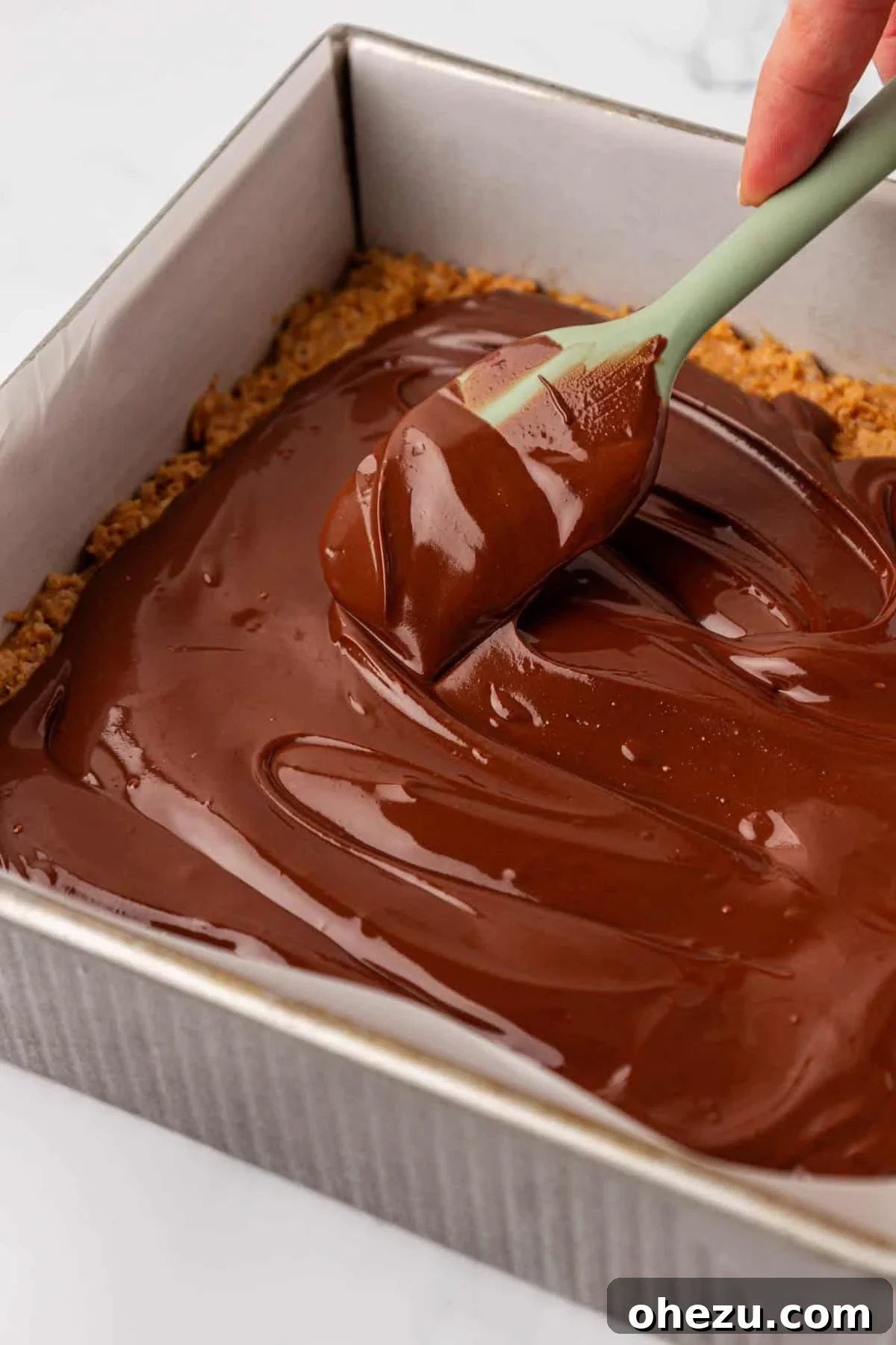 Chewy Peanut Butter Rice Krispie Bars Recipe 14 smoothing the melted chocolate over the rice krispies