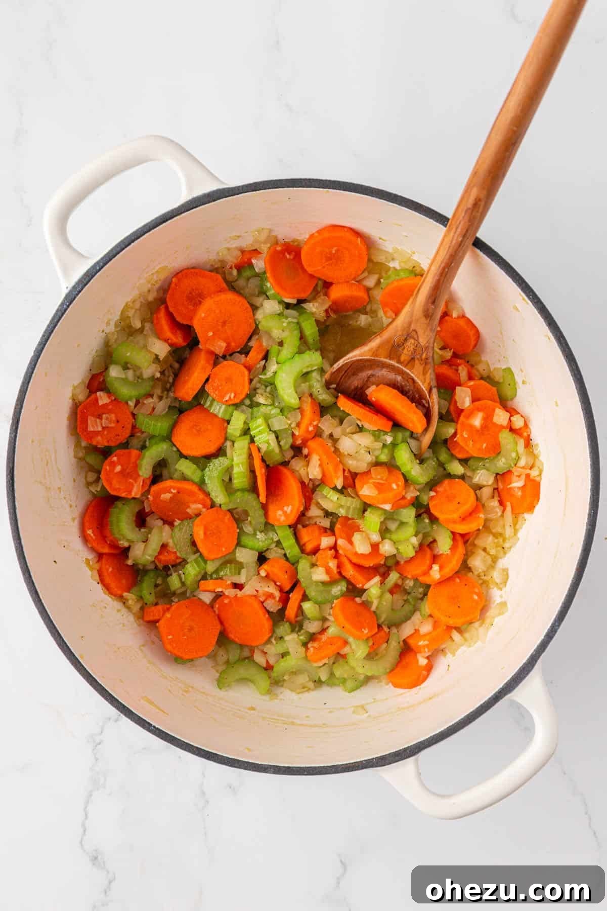stirring the vegetables while the cook